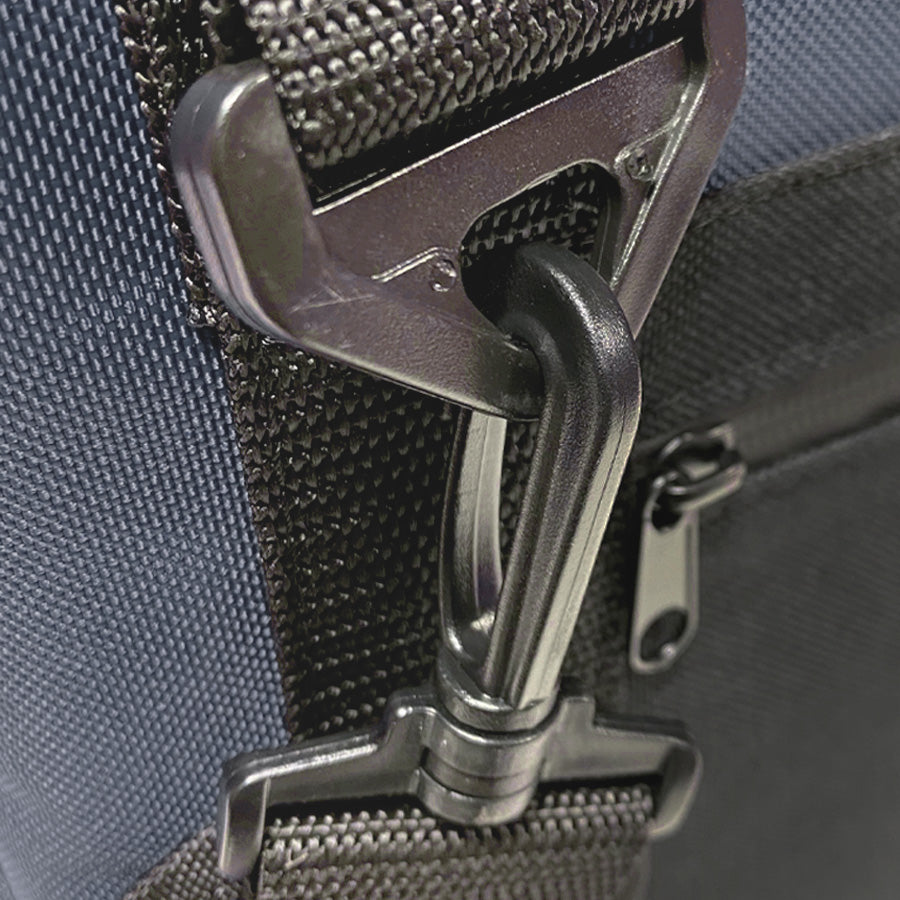 Close-up of nylon bag hardware with metal D-ring and zipper pull on cooler strap