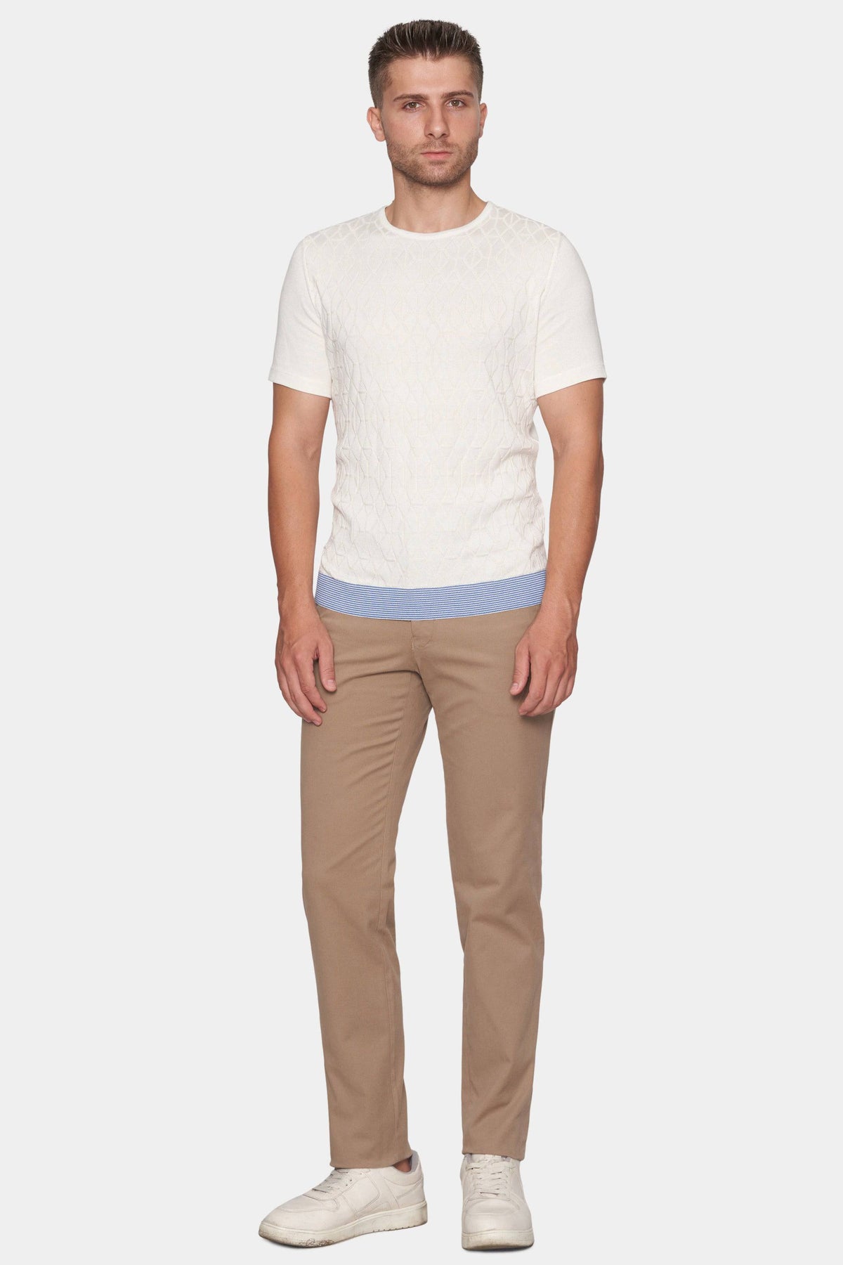 Tan chino pants with tapered legs, belt loops, and buttoned back pockets