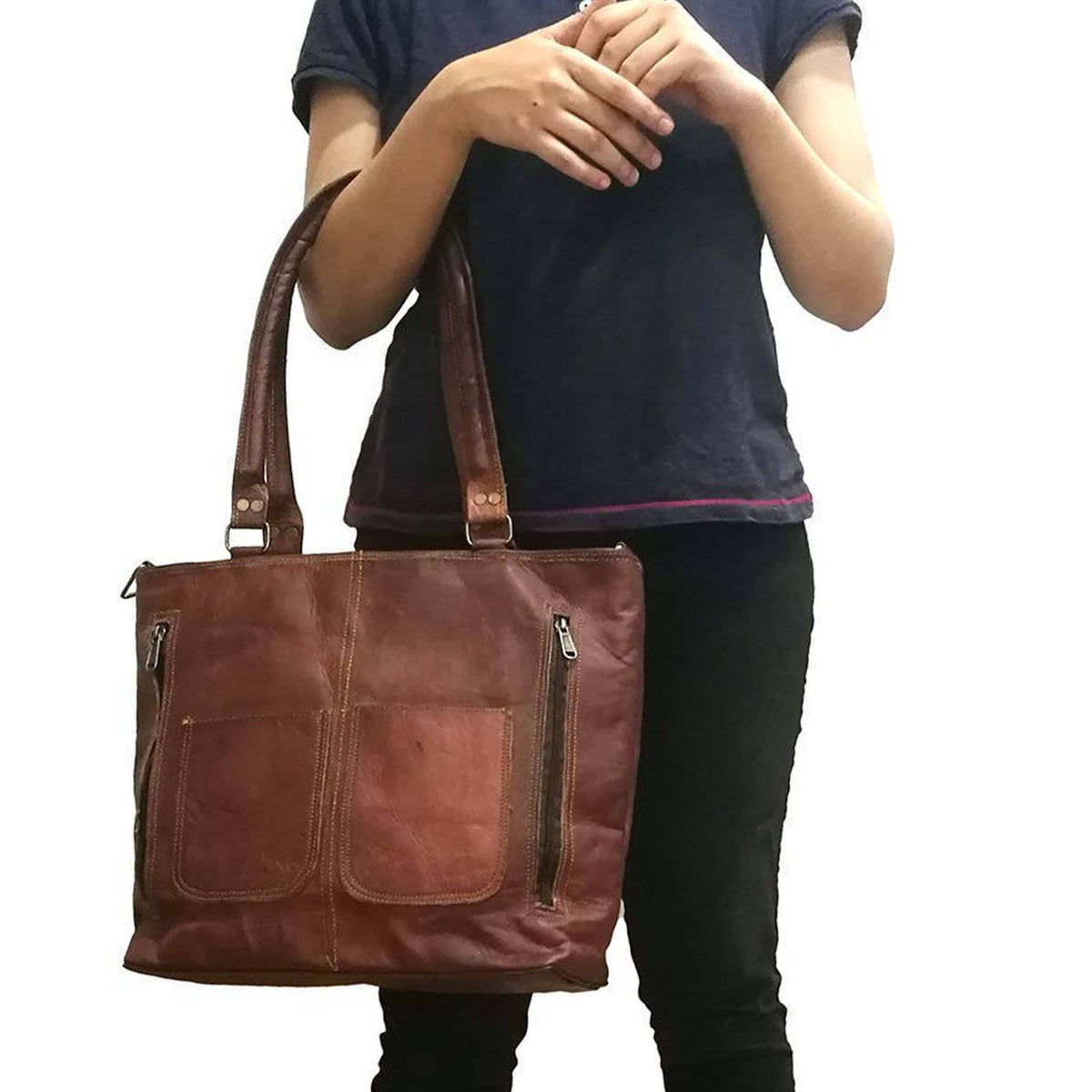 Terry tote bag held on shoulder; brown leather with front panel and two vertical zip pockets