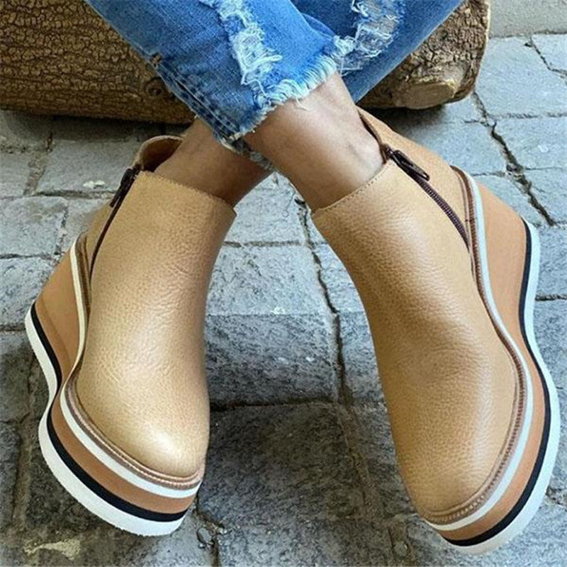 Women’s ankle wedge boots in light brown with side zipper and striped sole edge