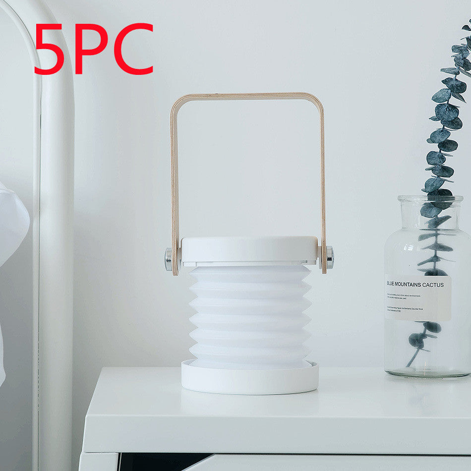 Foldable LED lantern with white ribbed shade, white frame and built-in handle