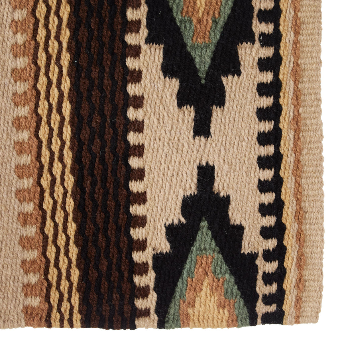 Wool saddle blanket close-up with black star and zigzag trim on cream striped fabric