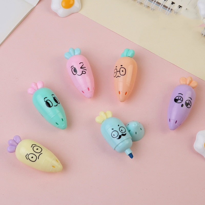 Pastel cartoon capsule highlighters set with smiling faces and pointed tips.