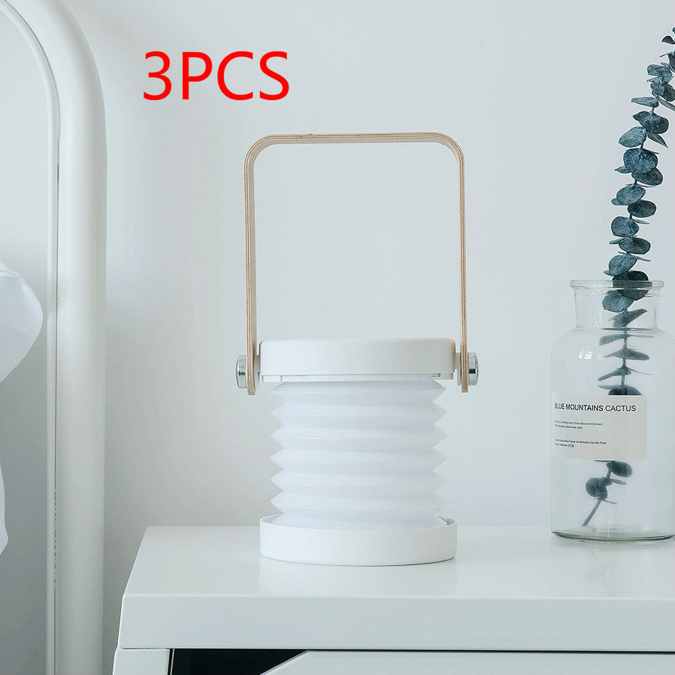 Foldable LED night light lantern with tan handle, ribbed white shade, blue base ring