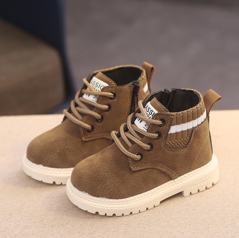Tan brown lace-up ankle boots with white striped collar and chunky white rubber sole