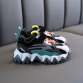 Chunky velcro sneakers in black with white panels, teal details, and orange laces