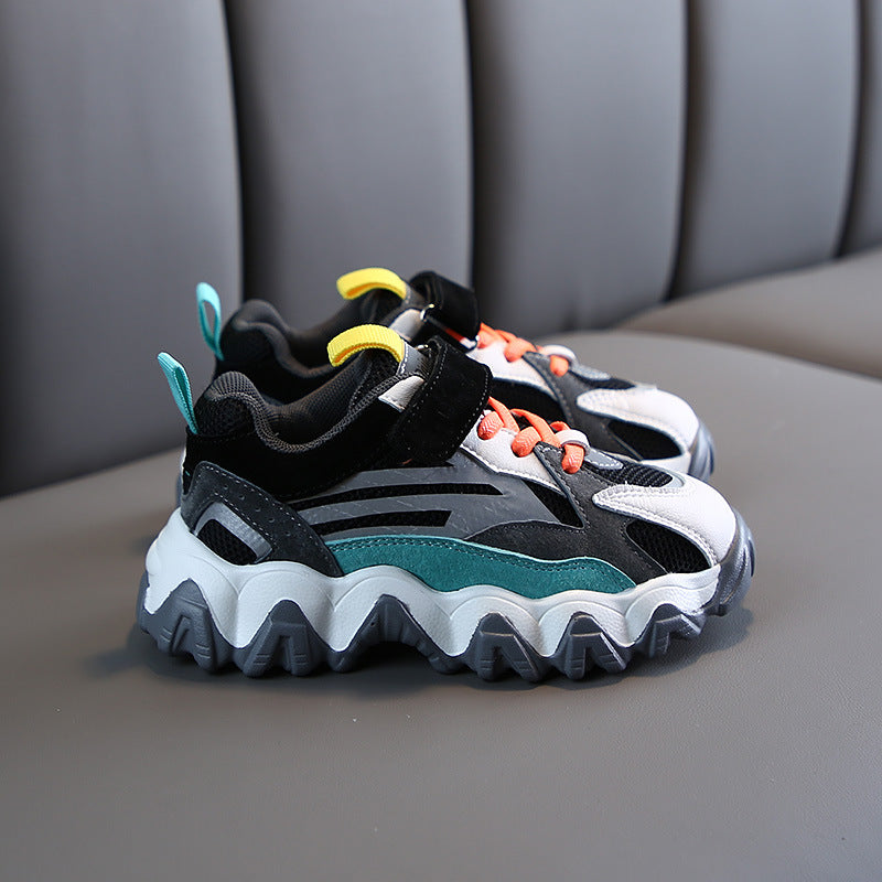Chunky velcro sneakers in black with white panels, teal details, and orange laces