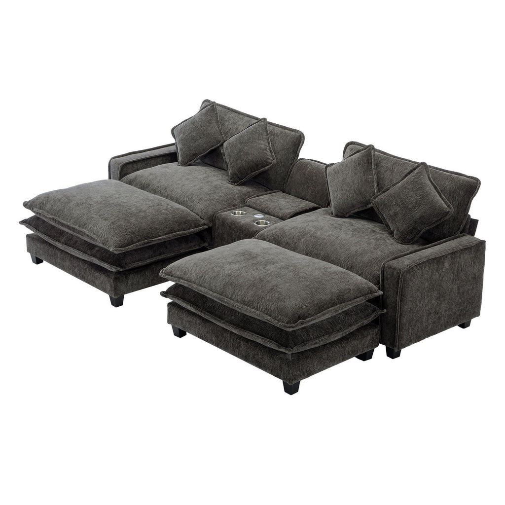 Dark gray sectional sofa with two ottomans extended and four accent pillows