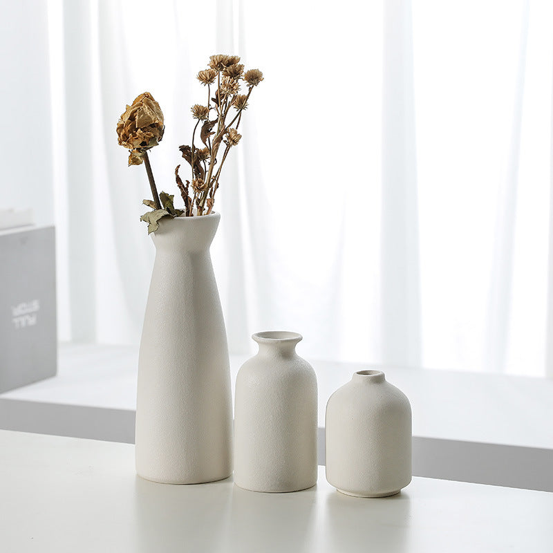 White ceramic vase decoration set of 3 narrow bottles, one filled with dried flowers