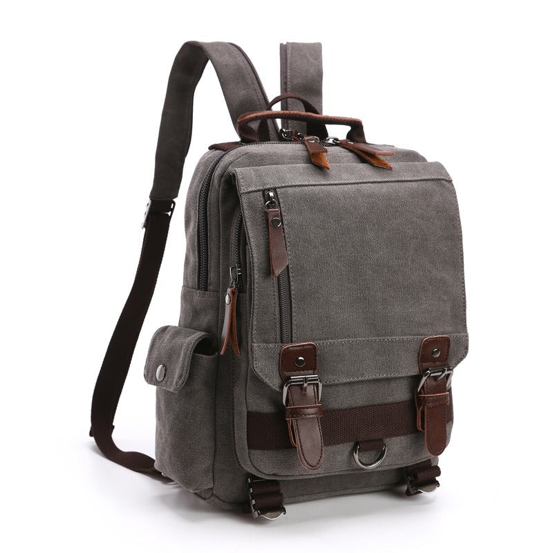 Gray canvas backpack with front flap pocket, side pouch, and adjustable shoulder strap