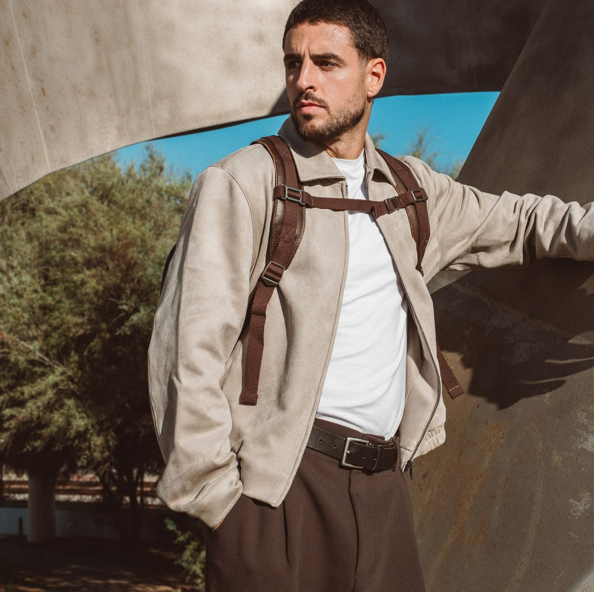 Sand canvas backpack with brown leather straps and adjustable buckles