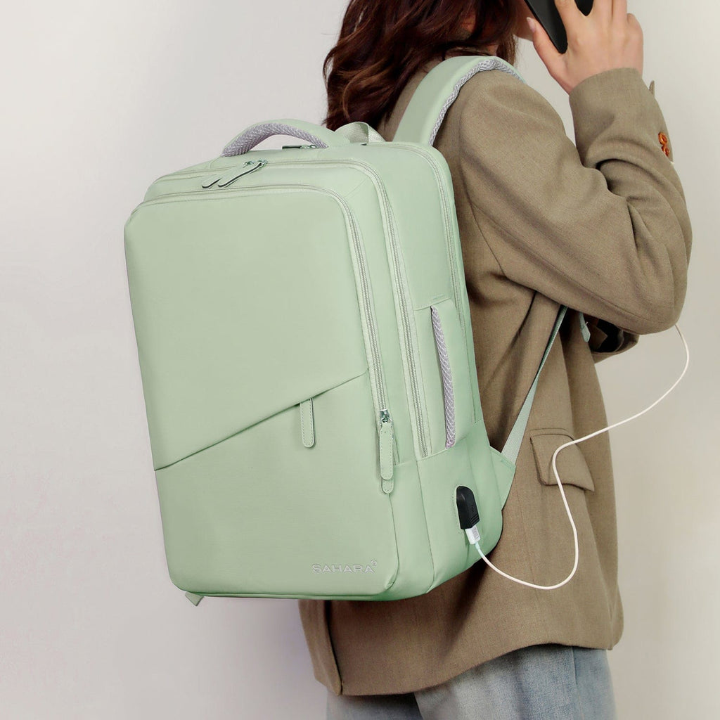 Mint green backpack worn on back with front cable port detail.