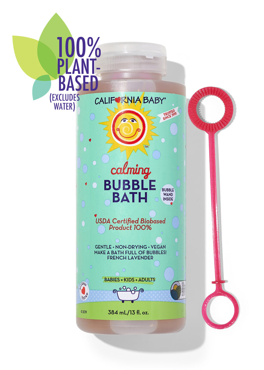 Bubble bath bottle with pink bubble wand accessory, blue-green label