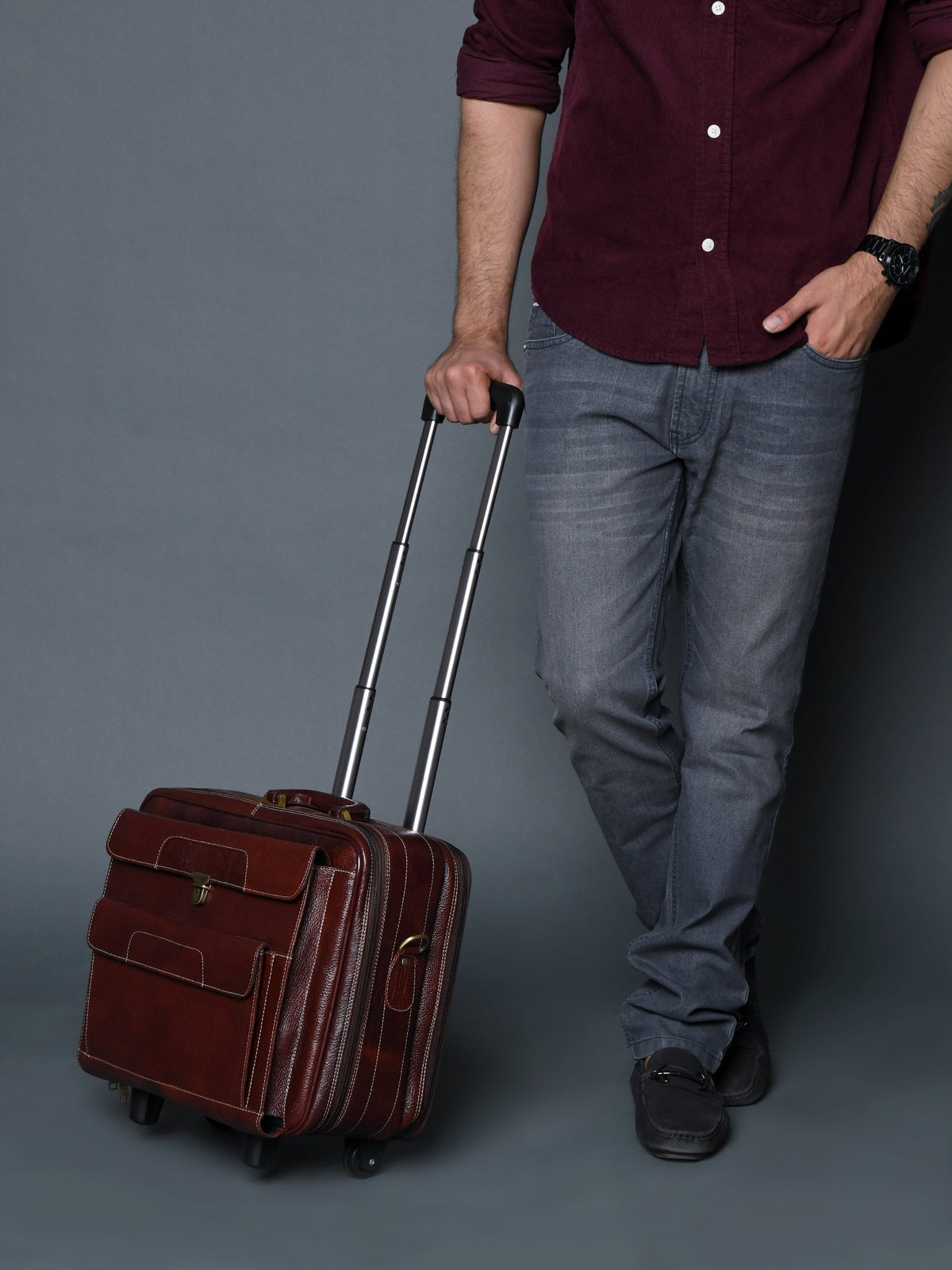 Brown leather trolley suitcase bag on wheels with extended telescopic handle