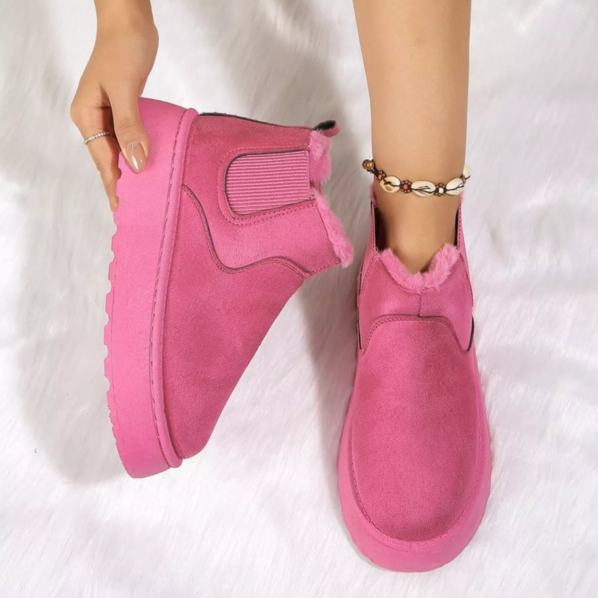 Hot pink suede platform ankle boots with round toe, side elastic gore, and faux fur trim