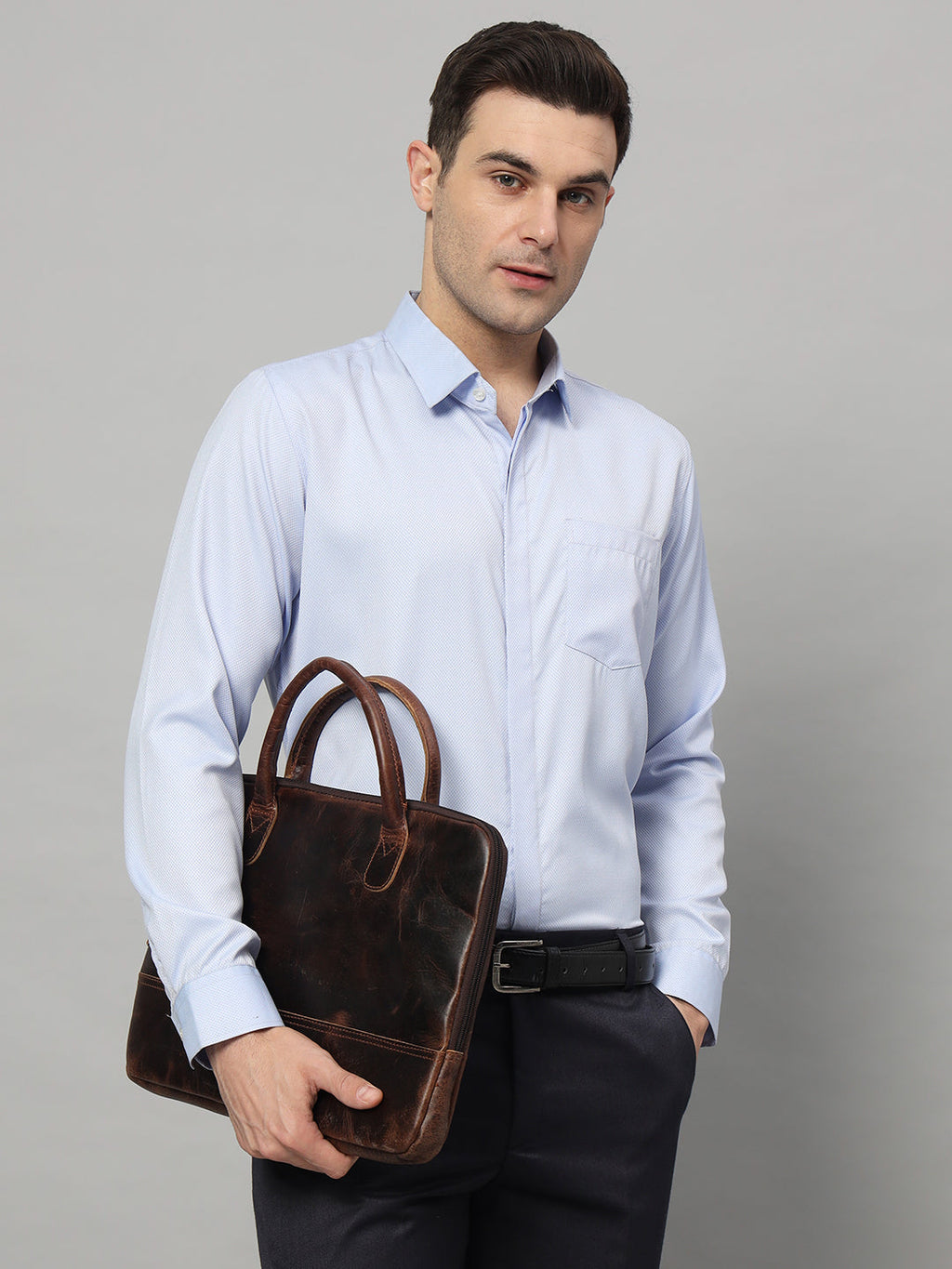 Dark brown leather laptop bag with top handles and front flap detail