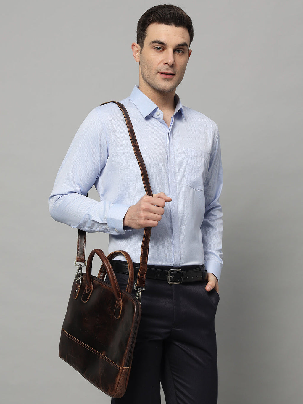 Dark brown leather laptop bag with top handles and long shoulder strap