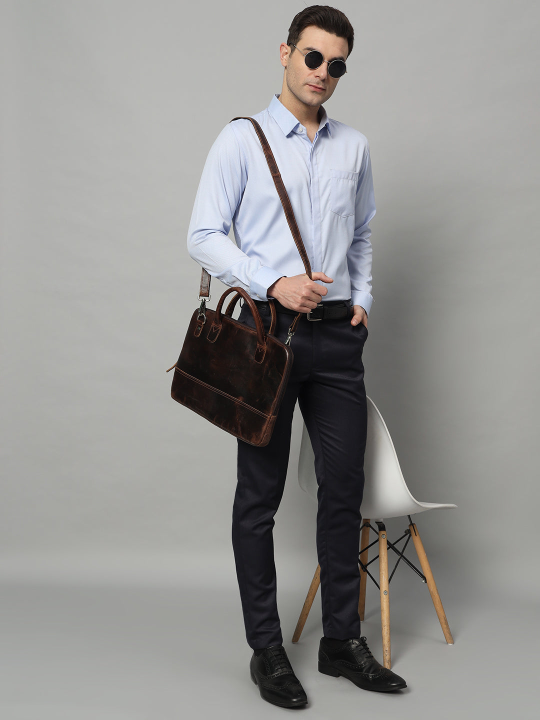 Dark brown leather laptop bag with side strap and structured top