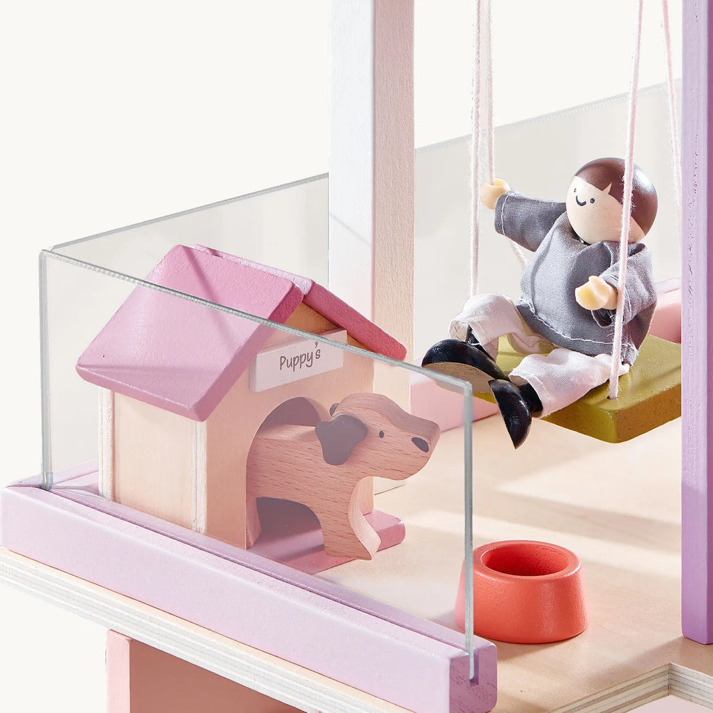 Pink dollhouse playroom with glass porch panel and small animal figure