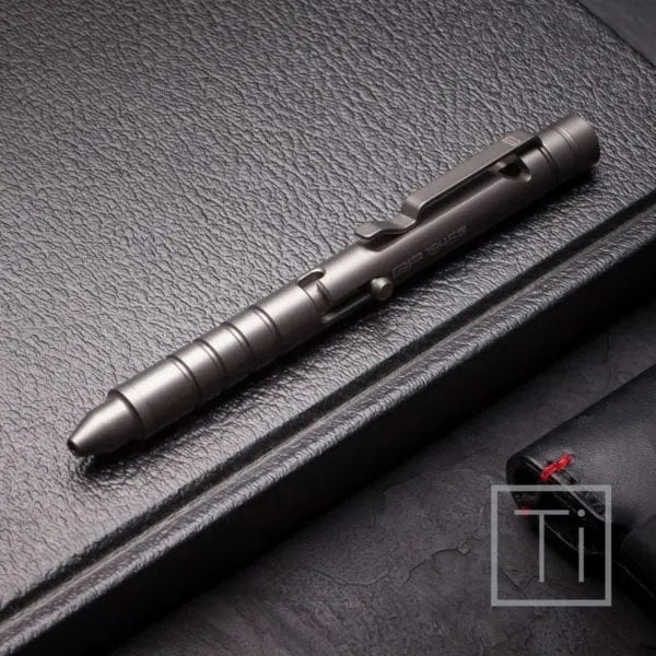 Bolt-action pen with dark metal body and clip detail, on textured surface