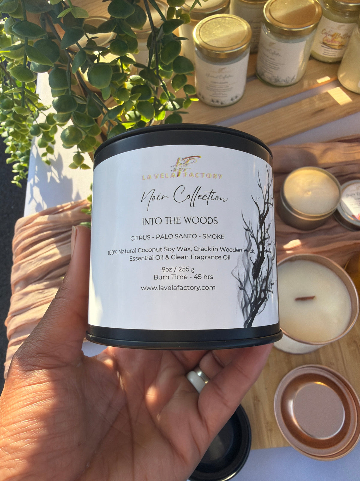 Amber glass jar candle with black lid, label for “Into the Woods”
