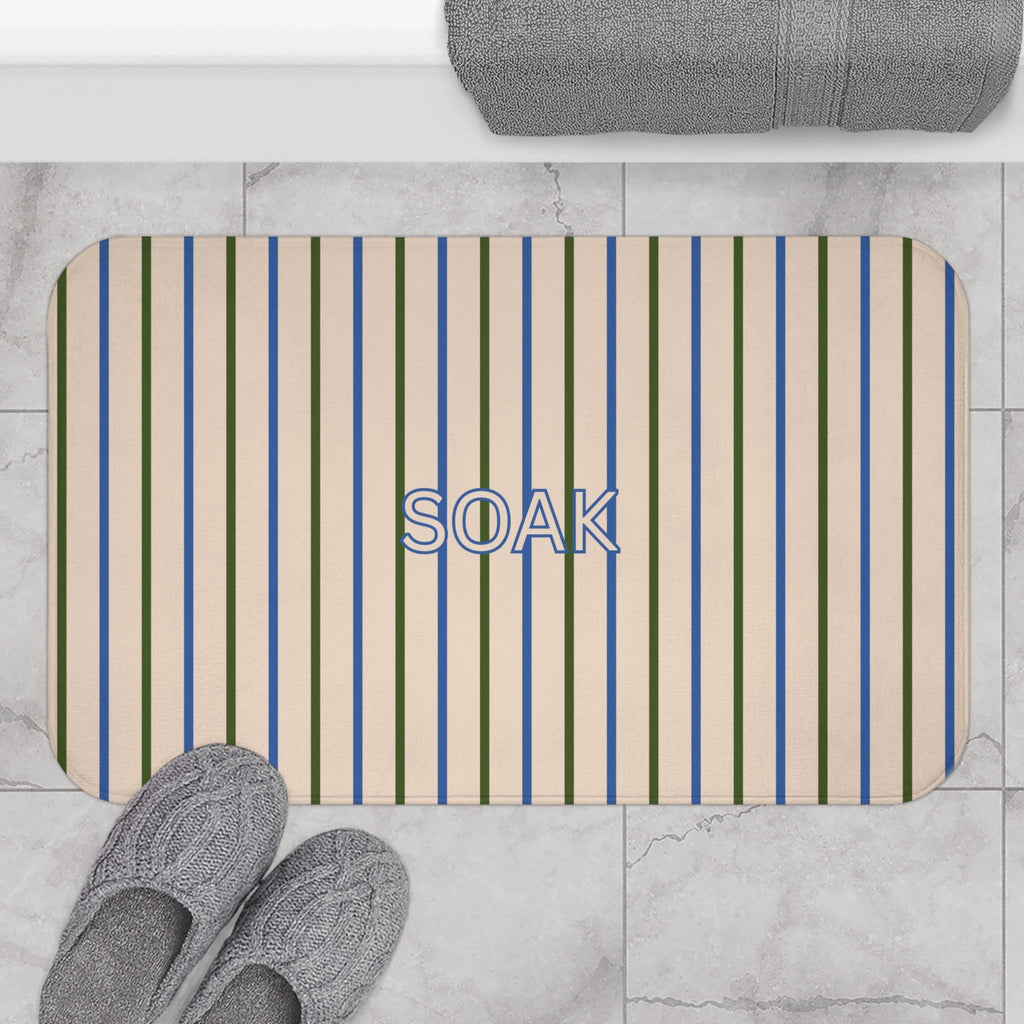 Striped bath mat with blue, green, and beige vertical stripes and stitched rounded edges