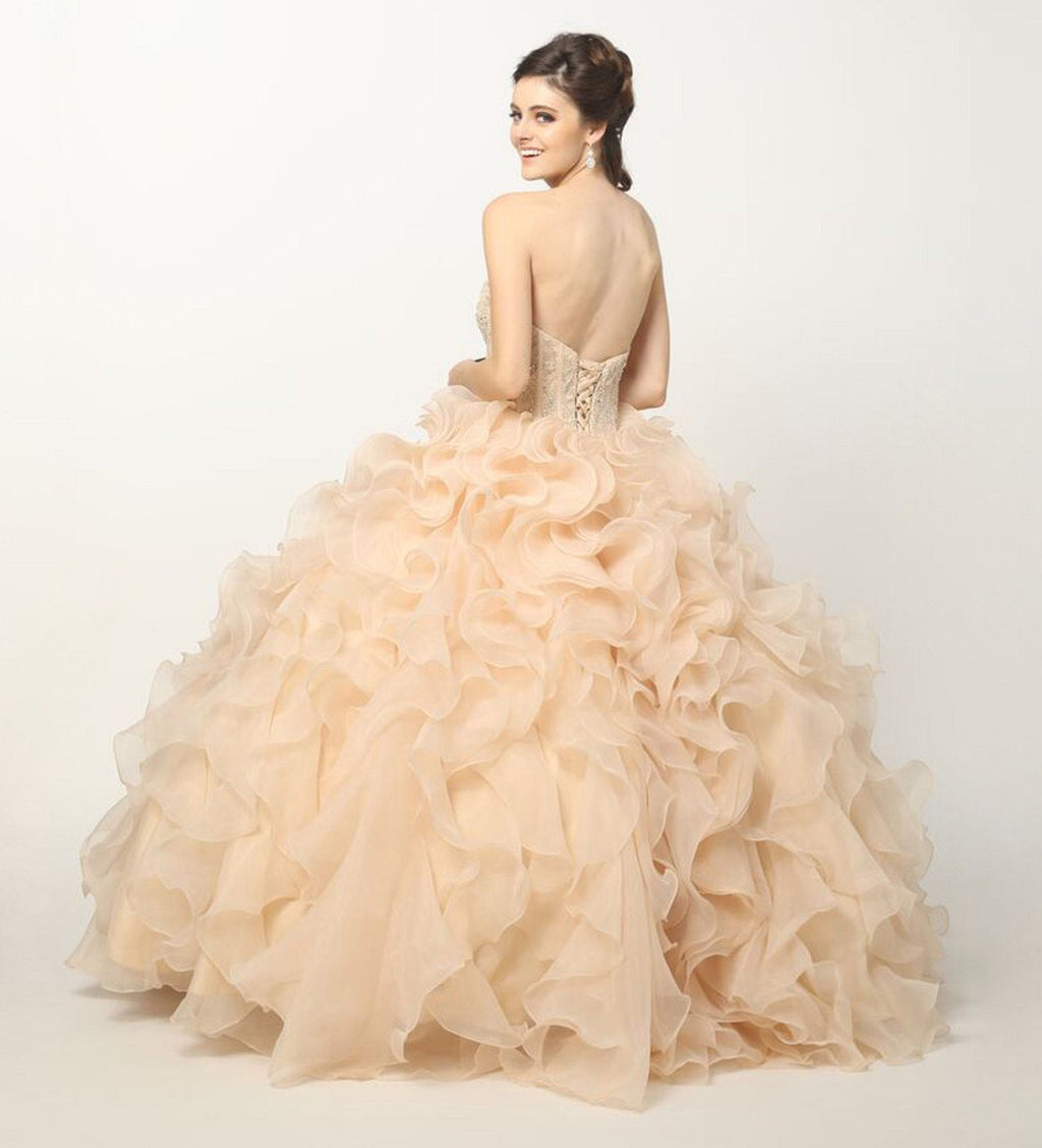 Champagne ball gown on model, side view; beaded corset bodice and organza ruffle skirt