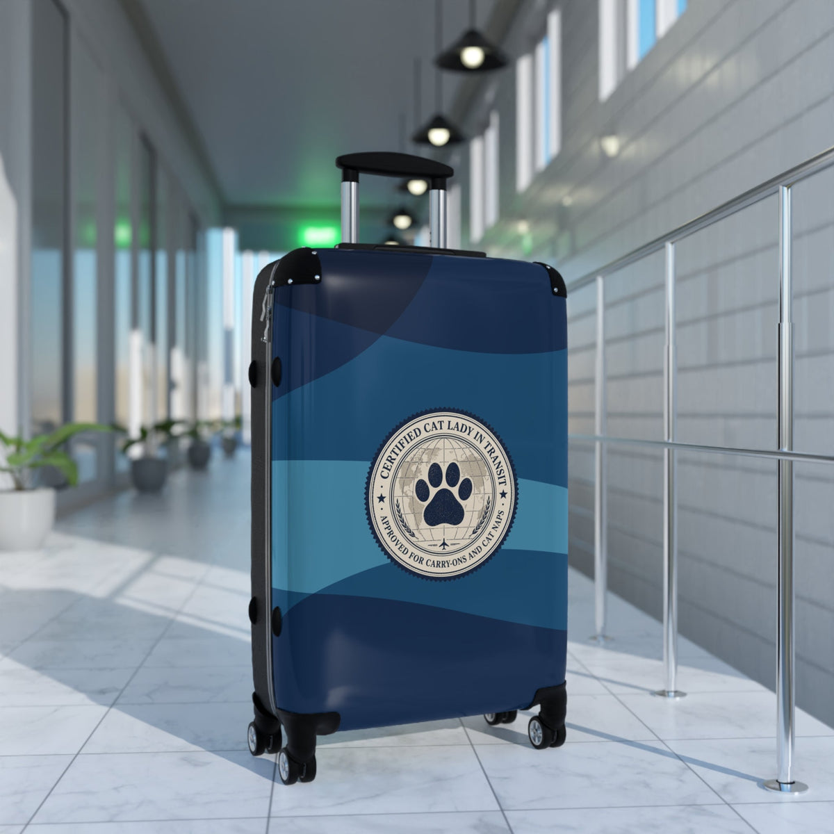 Hard-shell suitcase, blue with cat paw emblem and side carry handles