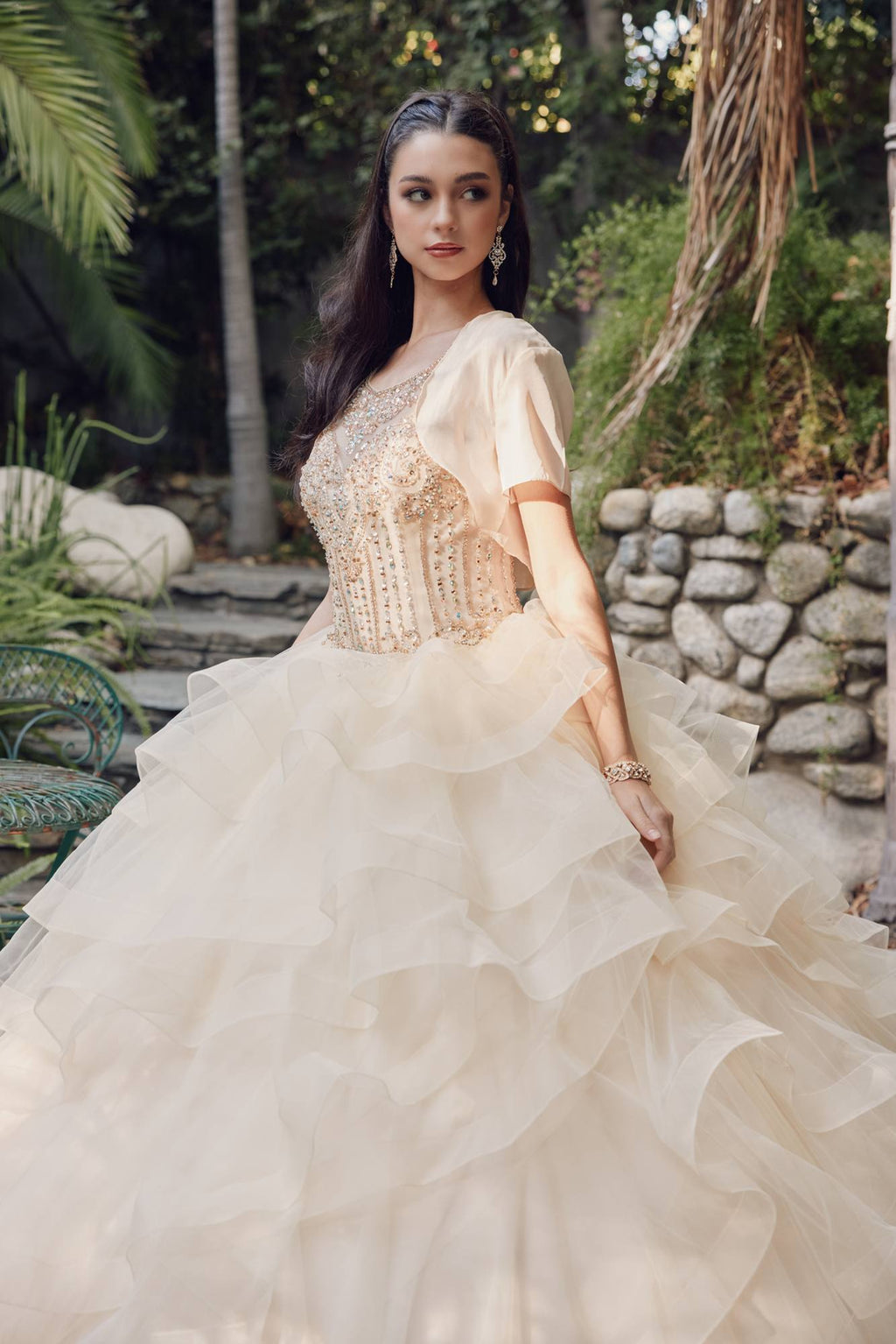 Champagne ball gown with beaded bodice, sheer tulle jacket sleeves, tiered skirt