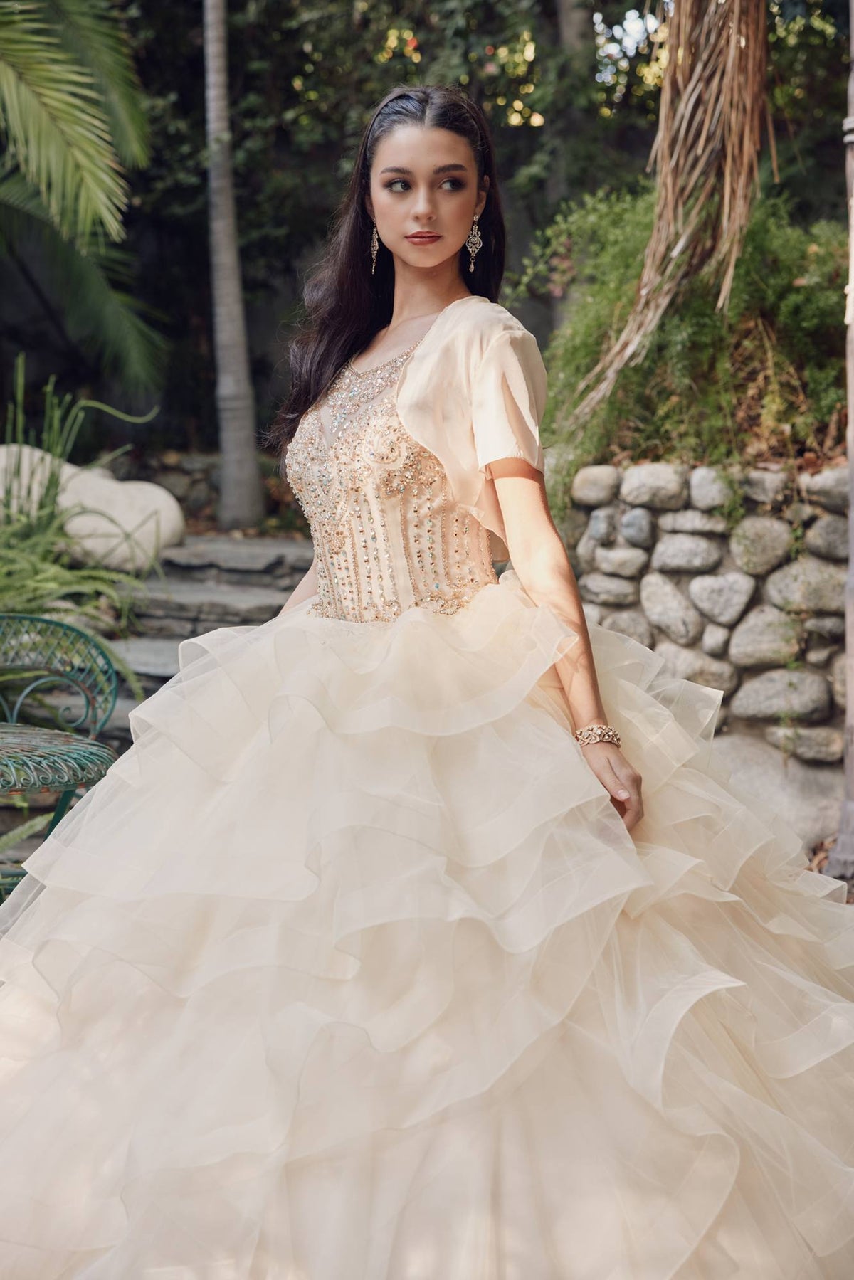 Champagne ball gown with beaded bodice, sheer tulle jacket sleeves, tiered skirt