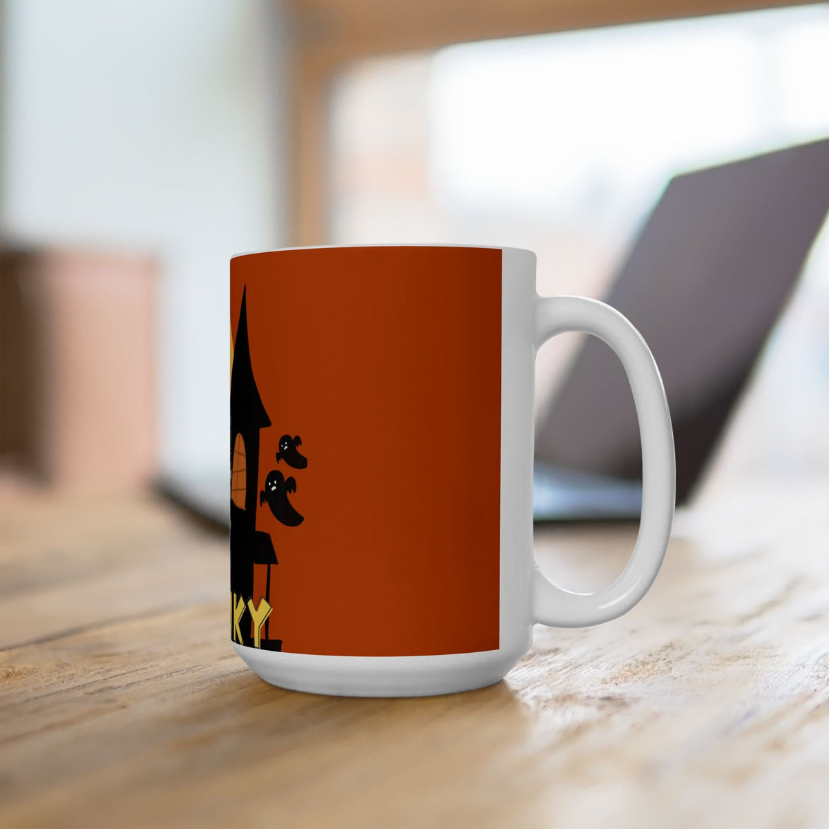 Orange ceramic Halloween mug with black silhouette graphic on side, white handle