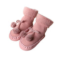 Pair of baby socks in rose pink with pom-pom bows and stitched edges