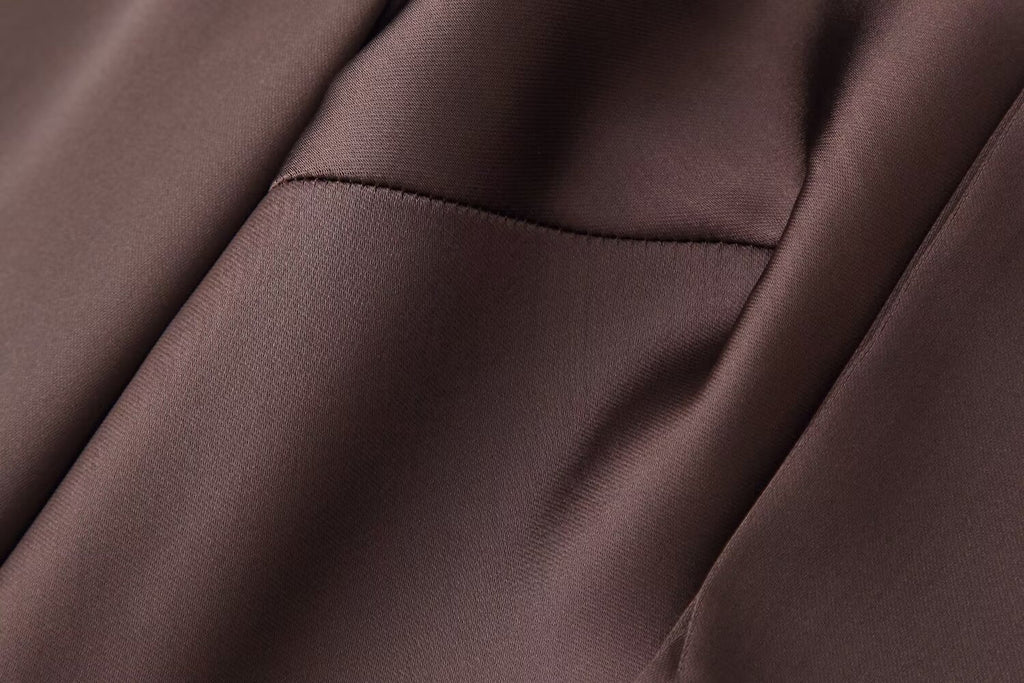 Dark brown satin fabric panel and seam detail on a women’s scarf dress