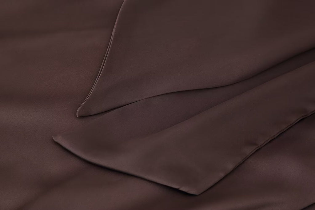 Dark brown satin pocket and seam detail on a women’s scarf dress