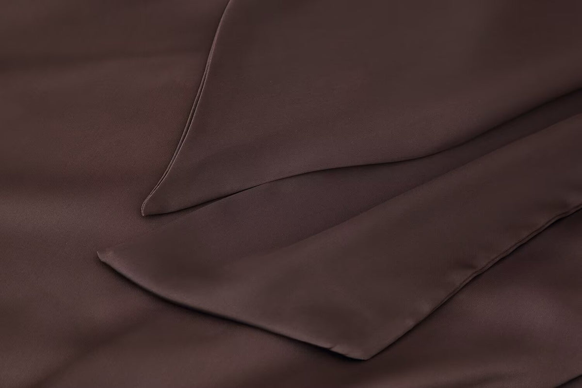 Dark brown satin pocket and seam detail on a women’s scarf dress
