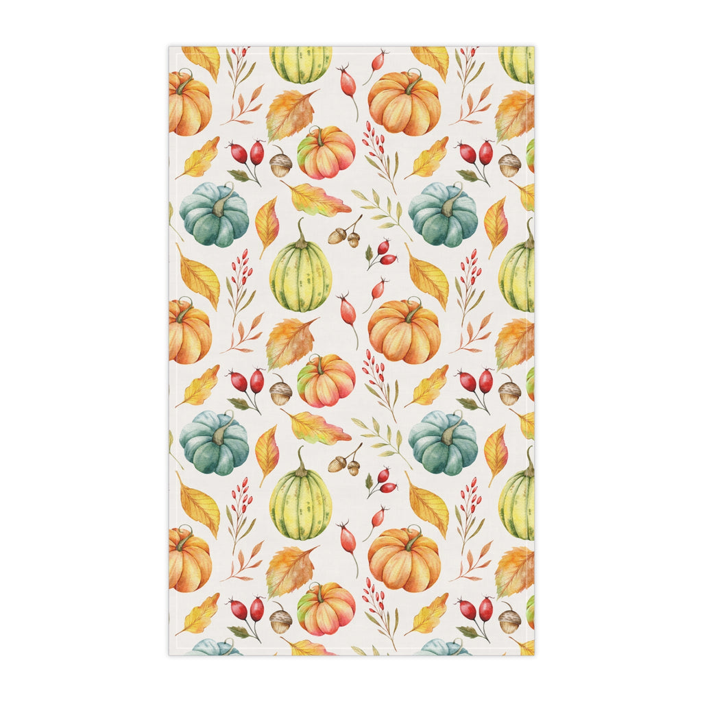 Cream autumn harvest tea towel, straight-on view, repeating pumpkin and leaf print.
