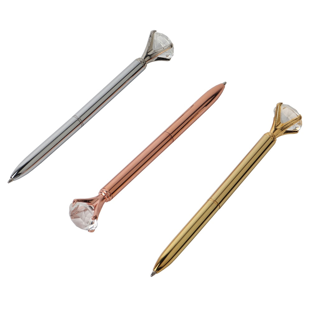 Gem-top metal ballpoint pens in silver, rose gold, and gold with faceted caps