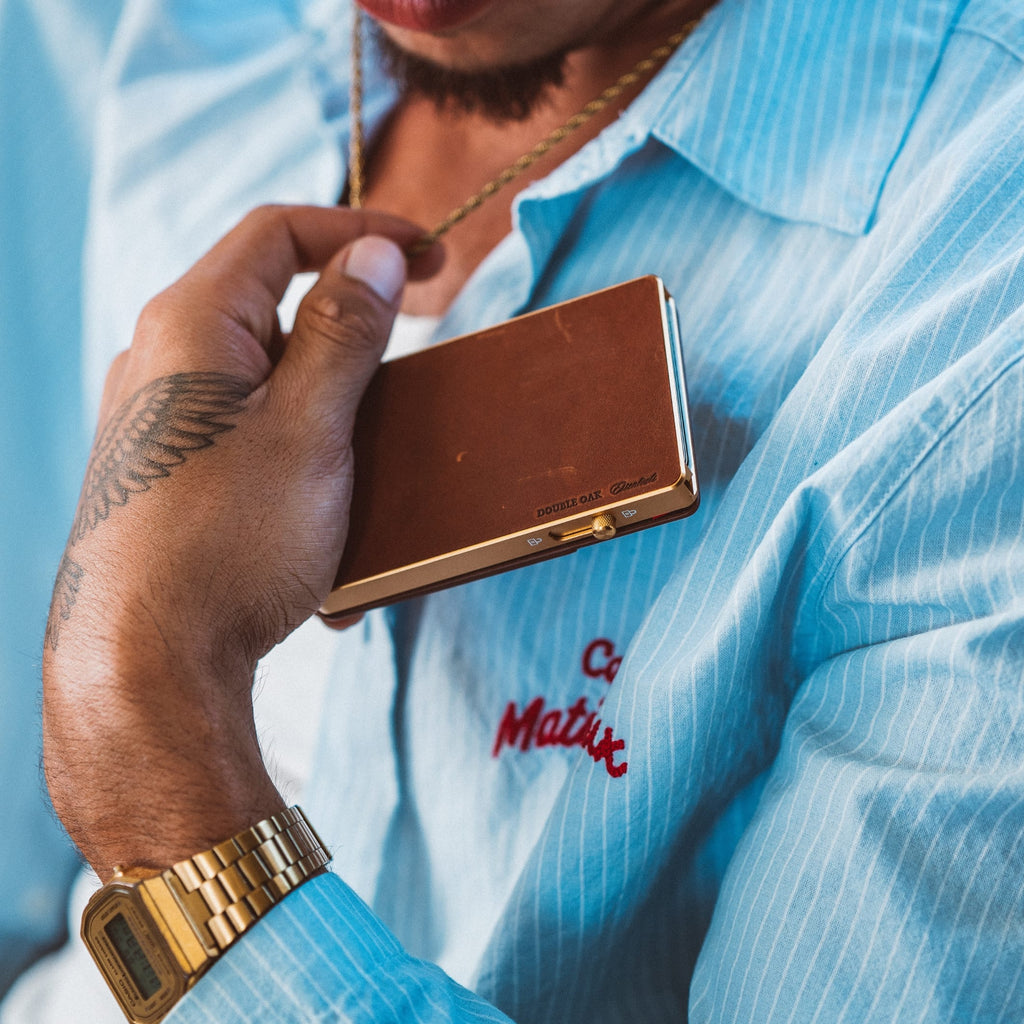 Brown leather Mod wallet with gold trim, secured card-facing display