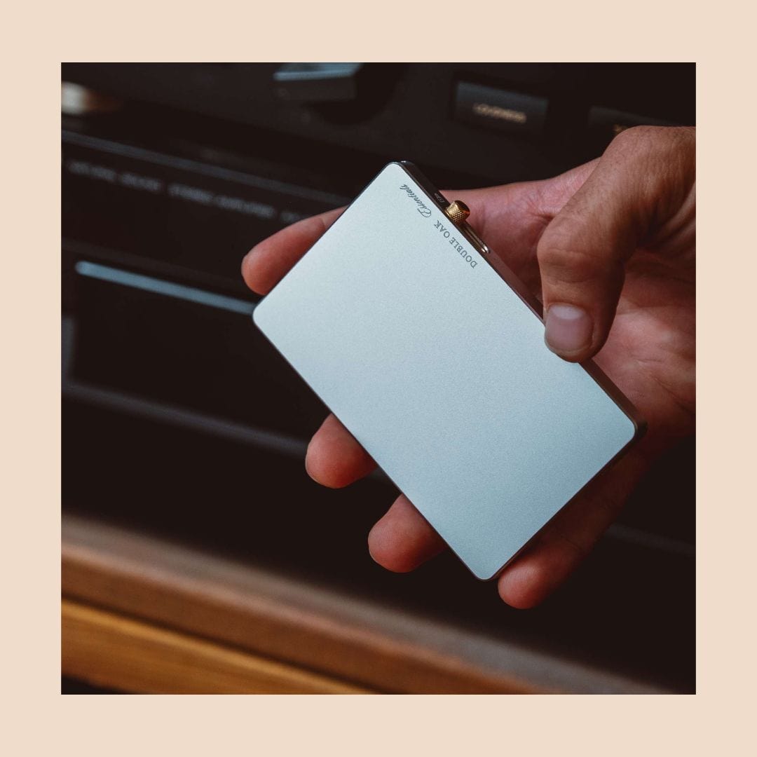 Light blue pop-up cardholder held in hand with card visible through window