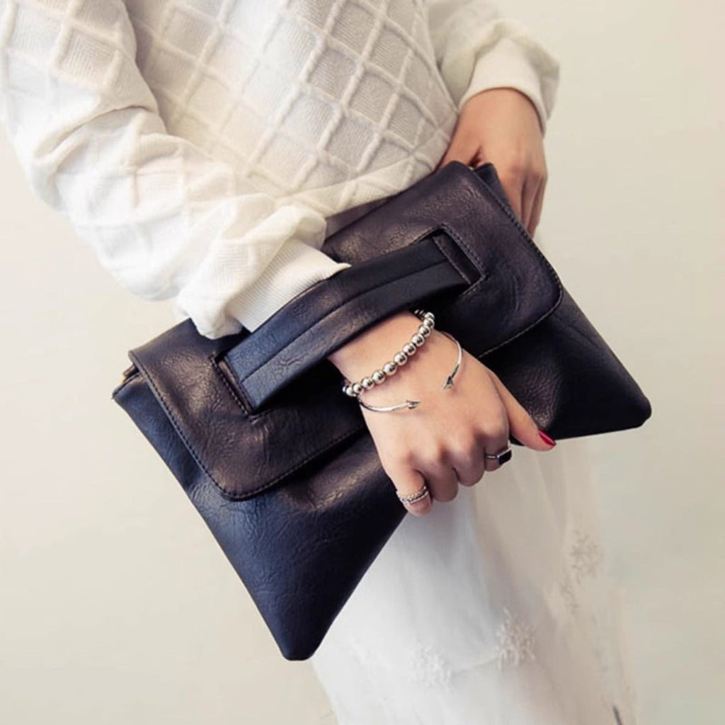 Dark brown leather envelope clutch purse with front flap and wide gusset opening