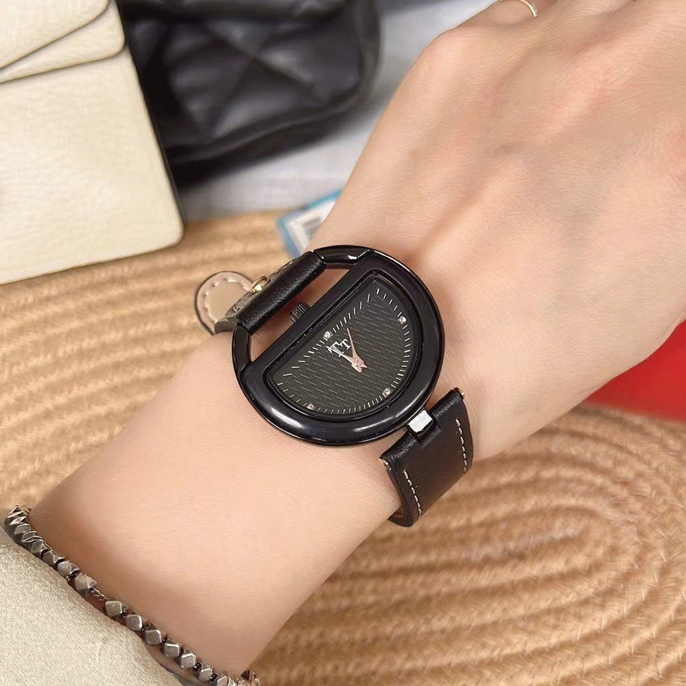 Women’s leather-strap watch with black band and black oval case, dark dial.
