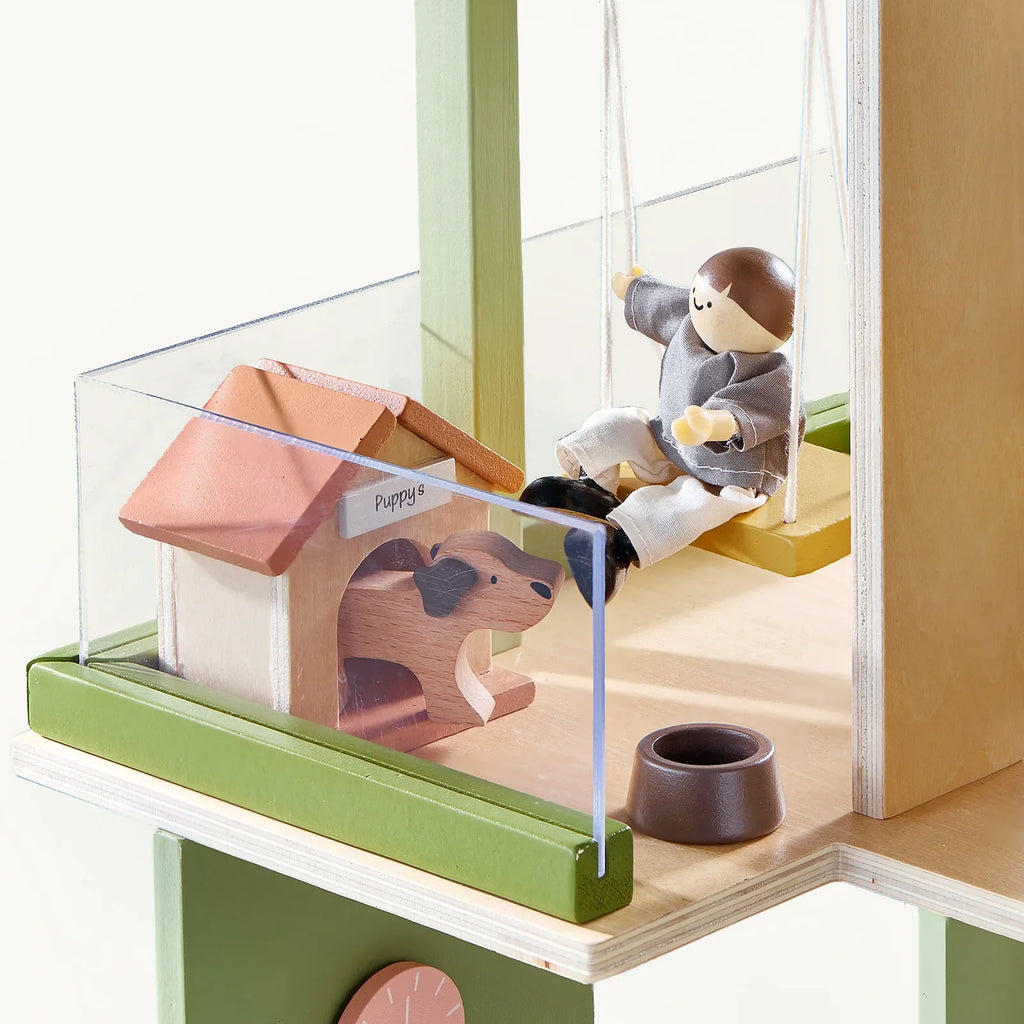 Green dollhouse balcony scene with toy animals and mini bench with drink container