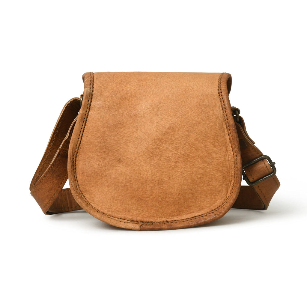 Tan leather saddle-style crossbody sling bag with adjustable strap and metal clasp