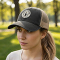 Black ponytail cap with mesh back and round logo patch