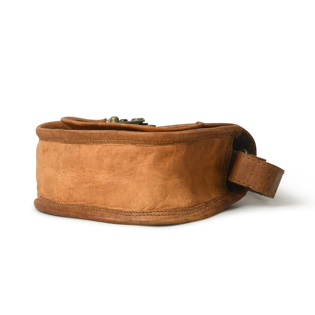 Tan leather crossbody sling bag side view with adjustable strap and D-ring hardware