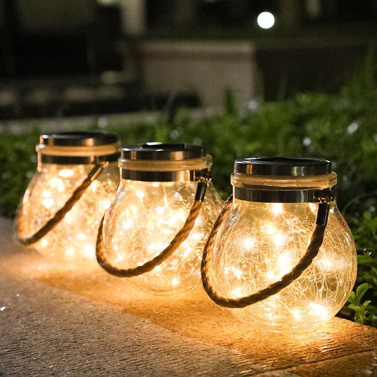Crackle glass jar lights with gold caps and curved rope handles