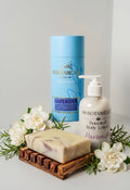 Luxury shower gift set with lavender body lotion pump, bar soap, and blue tin