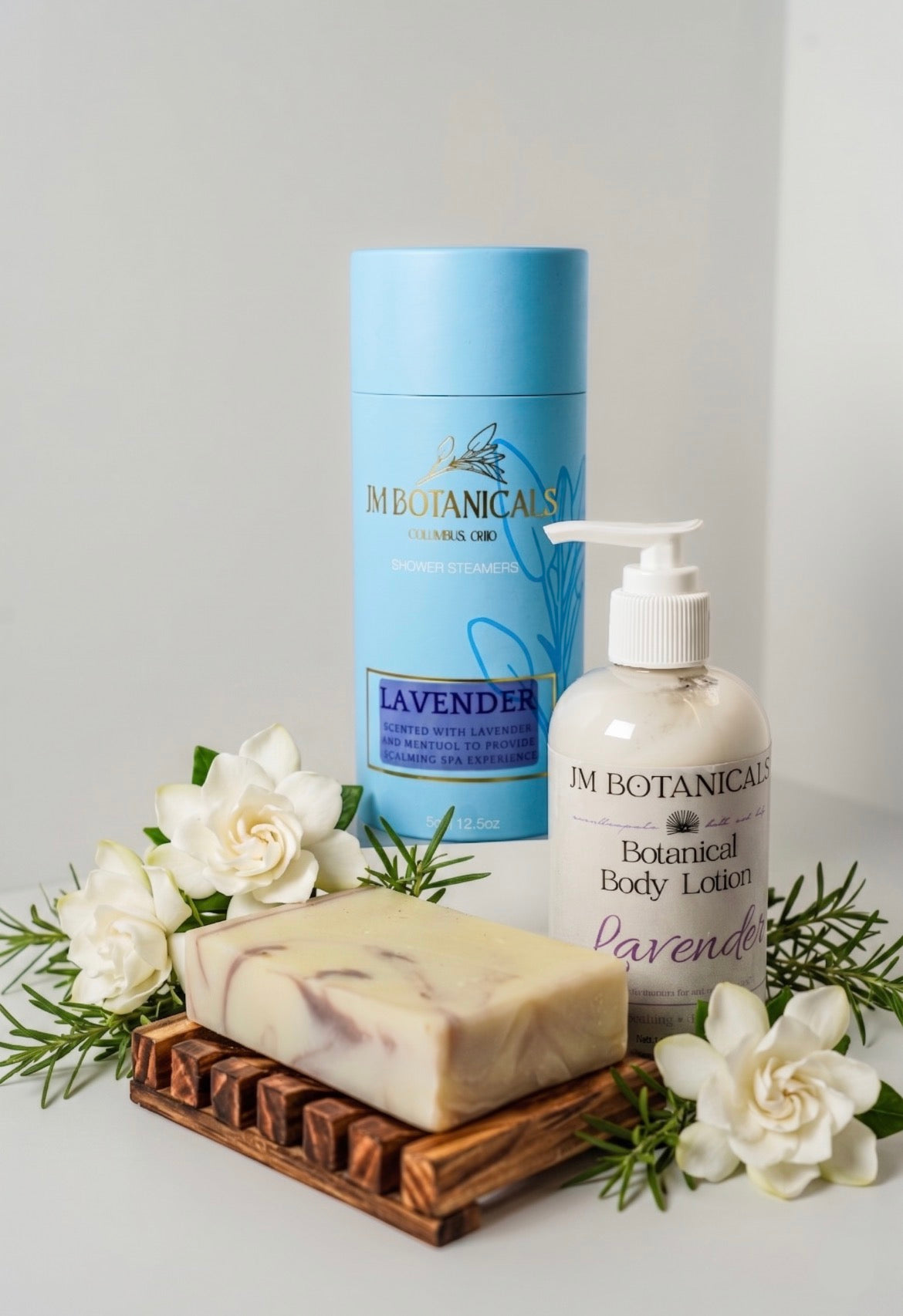Luxury shower gift set with lavender body lotion pump, bar soap, and blue tin