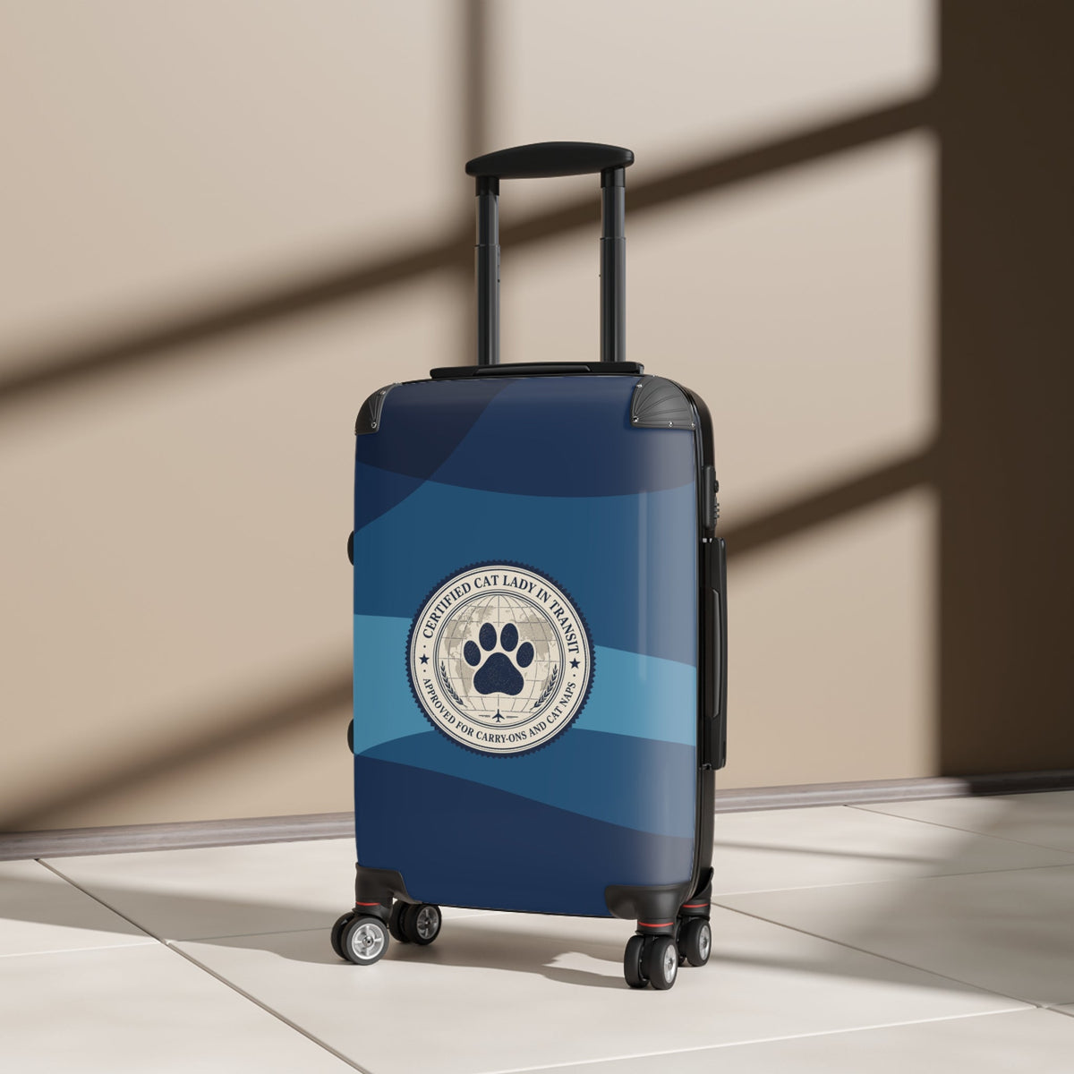 Hard-shell suitcase with paw emblem and telescoping handle, blue-and-dark striped shell