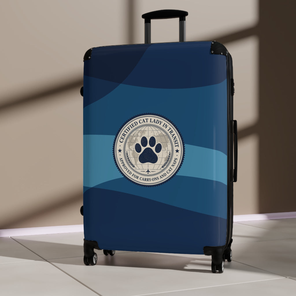 Blue hard-shell suitcase standing upright with paw seal emblem